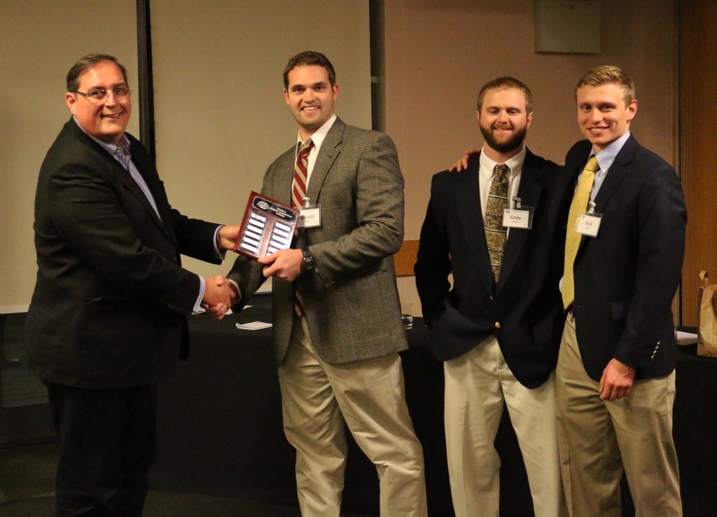 The winning team from Auburn University, presented with the trophy by Martin Perks, Divisional Director from Mott MacDonald, Ltd.